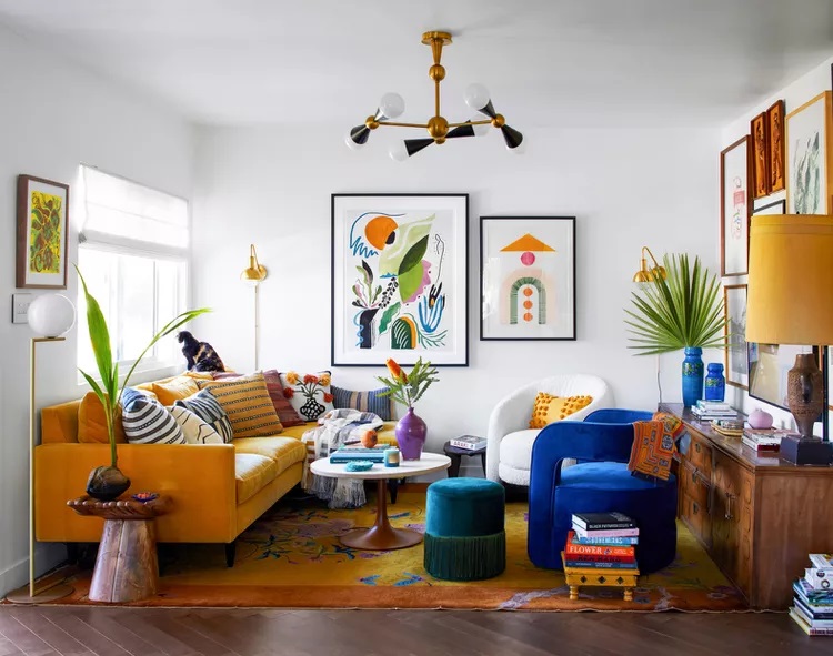 Eclectic living room with vibrant yellow couch, abstract wall art, and colorful accents.
